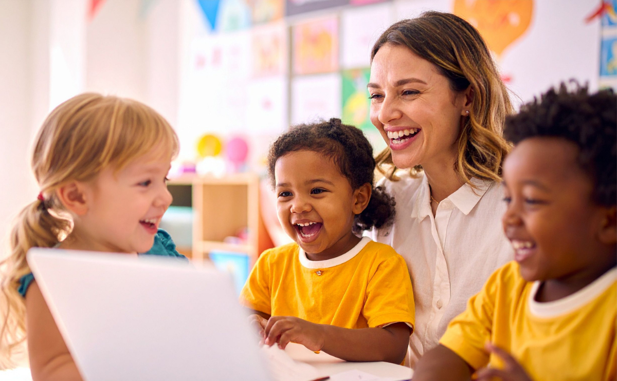 Preschool teacher looking at paper with laughing children