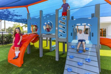 Children playing on daycare playground equipment